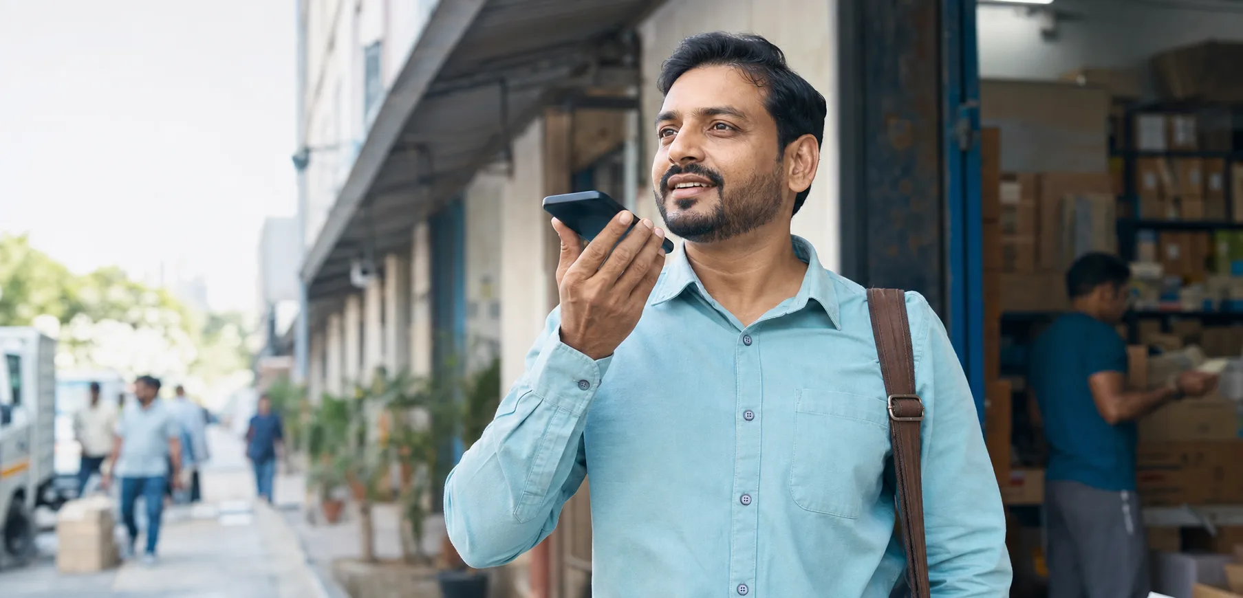 Indian field sales representative recording a WorkBuddy voice note after a distributor visit